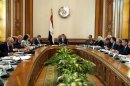 In this image released by the Egyptian Presidency, President Mohammed Morsi, center, meets with his cabinet including 10 new ministers after their swearing in at the presidential palace in Cairo, Egypt, Sunday Jan. 6, 2013. Egypt's government swore in 10 new ministers on Sunday in a Cabinet shake-up aimed at improving the government's handling of the country's struggling economy as foreign reserves levels slid closer to $15 billion, just enough to cover three months' worth of imports. (AP Photo/Egyptian Presidency)