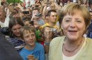 Visitors surround German Chancellor Merkel during open house day at the Chancellery in Berlin