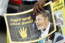 A member of the Muslim Brotherhood holds a poster during a protest in Cairo