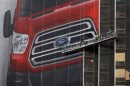 Workers hang a Ford Motor banner on the side of a building across from Cobo Center in advance of media preview of North American International Auto show in Detroit