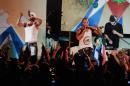 In this April 23, 2010 photo, members of Los Aldeanos, Aldo Rodriguez, left, and Bian Rodriguez, center, perform in concert at the Acapulco Theater in Havana, Cuba. Documents obtained by The Associated Press show that a U.S. agency infiltrated Cuba's hip-hop scene, recruiting unwitting rappers to spark a youth movement against the government. (AP Photo)