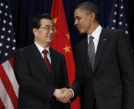 FILE - In this Nov. 12, 2011 file photo, U.S. President Barack Obama, right, meets with Chinese President Hu Jintao at the APEC Summit in Honolulu. In the simplistic narrative of U.S. presidential politics, China is a Hollywood villain, a monetary cheat that is stealing American jobs. But in the debate Tuesday night, Oct. 16, 2012 the one-dimensional caricature offered up by Obama and Republican challenger Mitt Romney obscures the crucial reality of U.S.-China relations: For all the talk about getting tough on Beijing, the U.S. and China are deeply entwined, defying easy solutions to the friction and troubles that beset their relations. (AP Photo/Charles Dharapak, File)