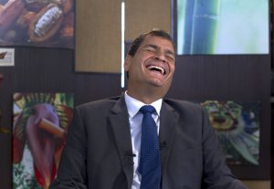 Ecuador's President Rafael Correa, laughs during a …