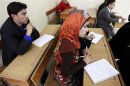 Syrian Kurds practise reading the Kurdish language at a school in Derik