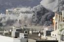 Smoke billows during an air strike on the Republican Palace in Yemen's southwestern city of Taiz