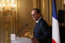 French President Hollande listens to a question during a news conference at the Elysee Palace in Paris