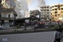 Crowd gathers at the site of a blast in Jaramana district, near Damascus