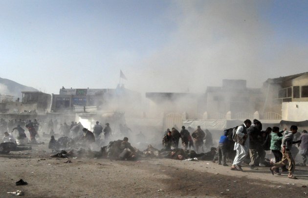 Smoke and dust rises at the scene of a suicide attack which struck a Muharram procession in Kabul, Afghanistan, Tuesday, Dec. 6, 2011. A suicide bomber struck a crowd of Shiite worshippers marking a h