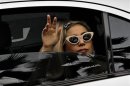 U.S. singer Lady Gaga waves to fans upon arriving at Changi Airport in Singapore