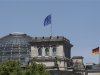 EU and German national flag are set up atop Reichstag building in Berlin
