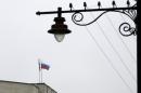 The Russian flag flies on a local government building in Simferopol, Crimea, Ukraine, Thursday, Feb. 27, 2014. Ukraine's acting interior minister says Interior Ministry troops and police have been put on high alert after dozens of men seized local government and legislature buildings in the Crimea region. The intruders raised a Russian flag over the parliament building in the regional capital, Simferopol, but didn't immediately voice any demands. (AP Photo/Darko Vojinovic)