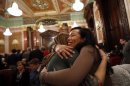 Santos hugs her partner of 21 years, Volpe, after a vote in a Committee hearing at the Illinois State Capital in Springfield, Illinois