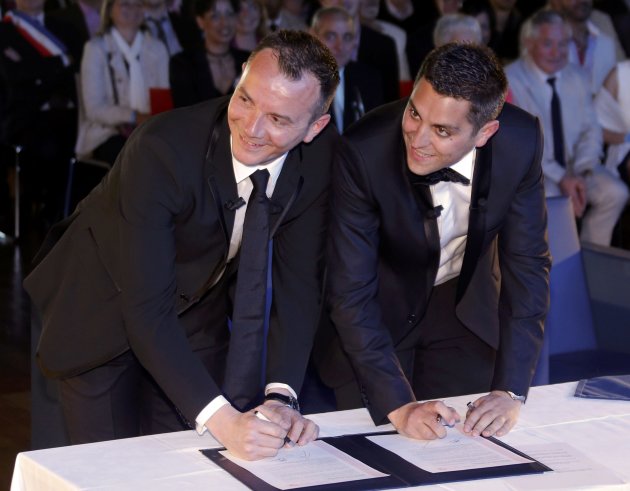 Vincent Autin and Bruno Boileau sign the register as they are married at the town hall in Montpellier