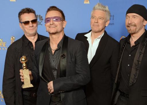 Larry Mullen Jr.(L), Bono, Adam Clayton and The Edge of U2 after winning a Golden Globe for Best Original Song for "Ordinary Love" from "Mandela: Long Walk to Freedom," in Beverly Hills, California, January 12, 2014