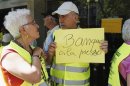A protester from "Yayoflautas" movement holds up sign during an occupation at the German Consulate in central Barcelona