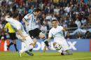 Argentina's Lionel Messi, center, scores past Slovenia's Miral Samardzic, right, and Bojan Jokic during their international friendly soccer match in La Plata, Argentina, Saturday, June 7, 2014. Argentina's team is leaving June 9 for Brazil to compete in the World Cup. (AP Photo/Natacha Pisarenko)