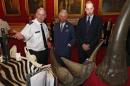 Britain's Princes Charles and William are shown items made from endangered animals in central London