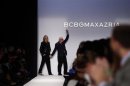Designer Max Azria acknowledges the crowd as he waves at the BCBG Max Azria Autumn/Winter 2013 collection during New York Fashion Week