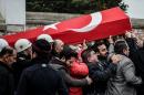 Mourners carry the coffin of a Turkish police officer killed in weekend bombings in Istanbul, on December 12, 2016