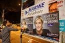 Members of the National Front youths put up posters of Marine Le Pen in Lyon