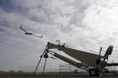 This photo taken March 26, 2013, shows an Insitu ScanEagle unmanned aircraft launched at the airport in Arlington, Ore. It's a good bet that in the not-so-distant future aerial drones will be part of Americans' everyday lives, performing countless useful functions. A far cry from the killing machines whose missiles incinerate terrorists, these generally small unmanned aircraft will help farmers more precisely apply water and pesticides to crops, saving money and reducing environmental impacts. They'll help police departments to find missing people, reconstruct traffic accidents and act as lookouts for SWAT teams. They'll alert authorities to people stranded on rooftops by hurricanes, and monitor evacuation flows. (AP Photo/Don Ryan)