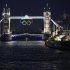 Olympic rings are illuminated while suspended from Tower Bridge