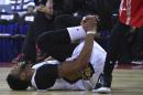 Anthony Davis of the New Orleans Pelicans reacts in pain as he injures his right ankle during a preseasons match against Houston Rockets in Beijing, China, Wednesday, Oct. 12, 2016. Davis fell to the court early in the first quarter of Wednesday's game in Beijing, the last of the NBA's two exhibitions in China. He re-entered the game briefly, but soon walked to the locker room. (AP Photo/Ng Han Guan)