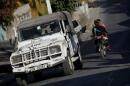 A United Nations car drives along a street of Port-au-Prince, Haiti