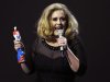 Adele speaks as she holds her award for best British female solo artist during the BRIT Music Awards at the O2 Arena in London