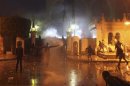 Protesters throw stones and molotov cocktails at security forces inside the presidential palace during clashes between protesters and police in front of the palace, in Cairo
