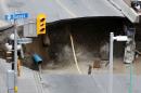 Dirt falls into a large sinkhole in Ottawa