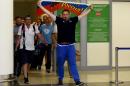 Russian football fan leader Alexander Shprygin holds a flag as he leaves the international airport Sheremetevo near Moscow on June 18, 2016