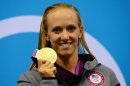 US swimmer Dana Vollmer (C) poses on the podium with the gold medal