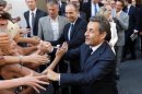 Former French President Sarkozy and French UMP political party head Cope leave the UMP political party headquarters in Paris