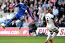Chelsea's French-born Senegalese striker Demba Ba (L) watches his shot as he scores during the English Premier League football match between Swansea City and Chelsea at the Liberty Stadium in Swansea on April 13, 2014