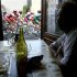 File photo of a man in a cafe looking out of the window at a pack of riders participating in the Tour de France cycling race between Nevers and Lyon