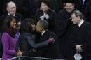 President Barack Obama kisses his wife Michelle after the ceremonial swearing-in at the U.S. Capitol during the 57th Presidential Inauguration in Washington, Monday, Jan. 21, 2013. Right is Chief Justice John Roberts. (AP Photo/Paul Sancya)