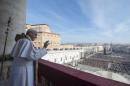 Pope Francis waves during the "Urbi et Orbi" Christmas message from the balcony overlooking St. Peter's Square at the Vatican