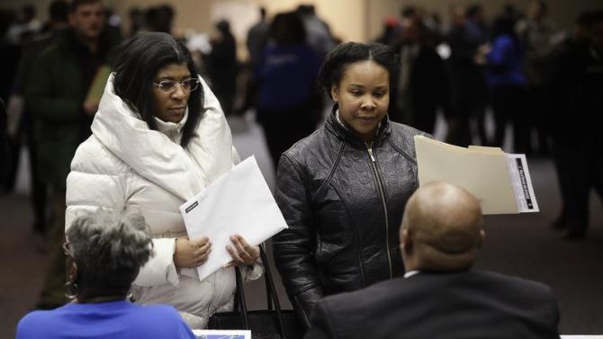 People attend a job fair in Detroit
