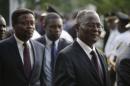 Haiti's provisional president Jocelerme Privert (R) walks followed by appointed prime minister Fritz Jean in the gardens of the National Palace in Port-au-Prince