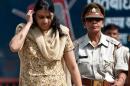 In this photograph taken on May 11, 2012, Nupur Talwar (L), mother and alleged murderer of Indian girl Aarushi, is escorted from the Dasna Jail to Ghaziabad Court around 40kms from New Delhi