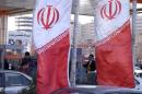 Iranian flags are seen at a petrol station in Tehran