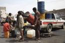A man sells black market fuel amid an acute shortage of fuel in Sanaa