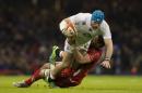 England's James Haskell, top, is tackled by Wales' Taulupe Faletau during their 6 Nations Championship Rugby match at the Millennium Stadium, Cardiff, Friday Feb. 6, 2015. (AP Photo/Jon Super)