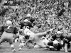 FILE - In this Oct. 27, 1973, file photo, Notre Dame's Greg Collins, bottom right, tries to make the tackle as Southern California's Anthony Davis reaches for a 4-yard gain during the first quarter of their NCAA college football game in South Bend, Ind. Notre Dame's Tim Rudnick (7), Gary Potempa (40), Ross Browner (89) and Mike Fanning (88) help on the play. Three field goals by Bob Thomas, an 85-yard touchdown run by Eric Penick and stingy run defense helped Notre Dame end Southern California's winning streak at 23 games with a 23-14 victory. The Associated Press takes a look at some of the memorable games in college football's greatest intersectional rivalry in anticipation of Southern California hosting No. 1 Notre Dame on Saturday, Nov. 24, 2012. (AP Photo/Charles Knoblock, File)