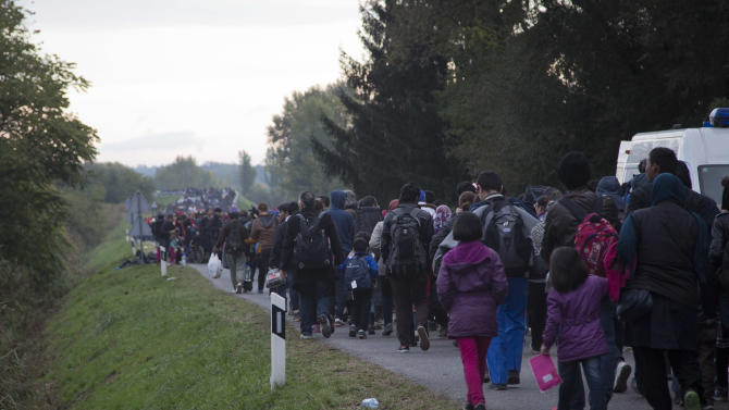 People walks towards Hungary after disembarking from a train in Botovo, on the Croatia-Hungary border, Friday, Oct. 16, 2015. Hungary clamped down on its border with Serbia with a barrier on Sept. 15 and says it will close down its border with Croatia to migrants starting at midnight. More than 383,000 migrants have entered Hungary this year, nearly all passing through on their way to Germany and other destinations farther west in the EU. (AP Photo/Darko Bandic)