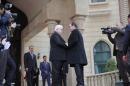 French President Francois Hollande is greeted by his Iraqi counterpart Fuad Masum upon his arrival at the presidential palace in Baghdad