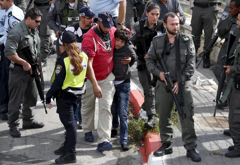 File photo of Israeli police leading away a Palestinian minor they said stabbed an Israeli security guard in Pisgat Zeev