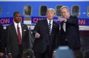 In this photo taken Wednesday, Sept. 16, 2015, Republican presidential candidates, from left, Ben Carson, Donald Trump, and former Florida Gov. Jeb Bush chat during the CNN Republican presidential debate at the Ronald Reagan Presidential Library and Museum in Simi Valley, Calif. Donald Trump's rivals emerged from the second Republican debate newly confident that the brash billionaire will fade if the primary takes a more substantive turn and that they can play a role in taking him down without hurting their own White House ambitions. Yet in a race that has so far defied standard political logic, that may be little more than wishful thinking. (AP Photo/Mark J. Terrill)