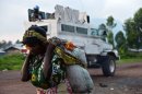 A Congolese woman walks past an armoured vehicle of the MONUSCO near Goma on September 4, 2013